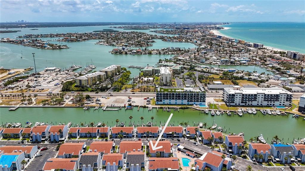 230 Medallion Boulevard, Unit G Madeira Beach, FL 33708 - Photo 43 of 44 an aerial view of a city with lawn chairs