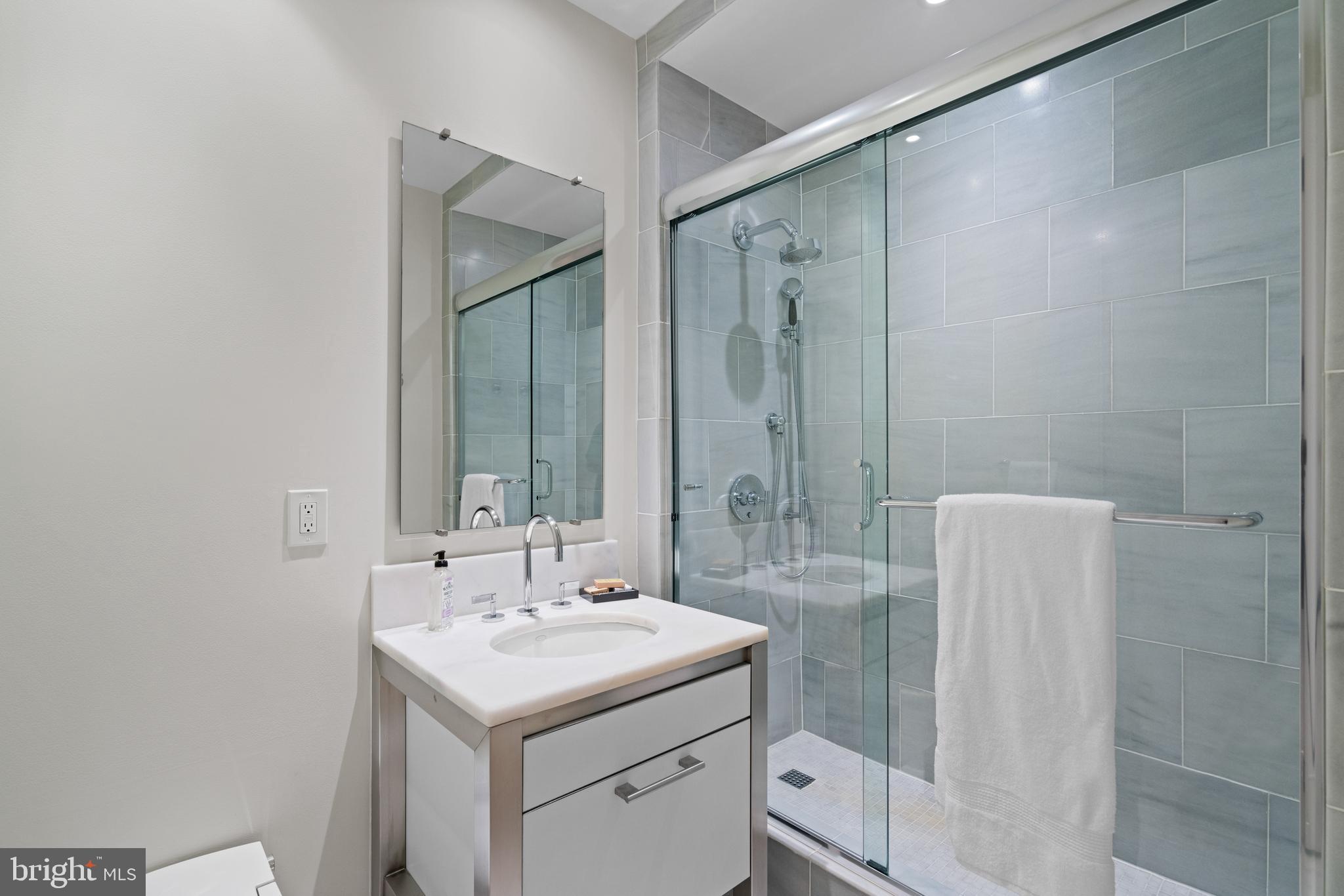 3303 Water Street Northwest, Unit 3B Washington, DC 20007 - Photo 13 of 25 a bathroom with a sink and a mirror