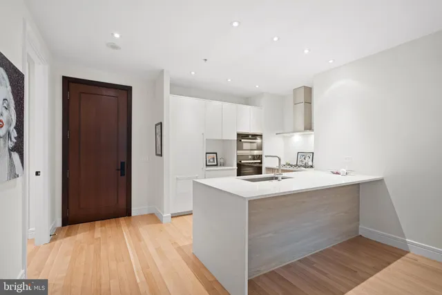 a kitchen with a sink a stove a refrigerator and cabinets