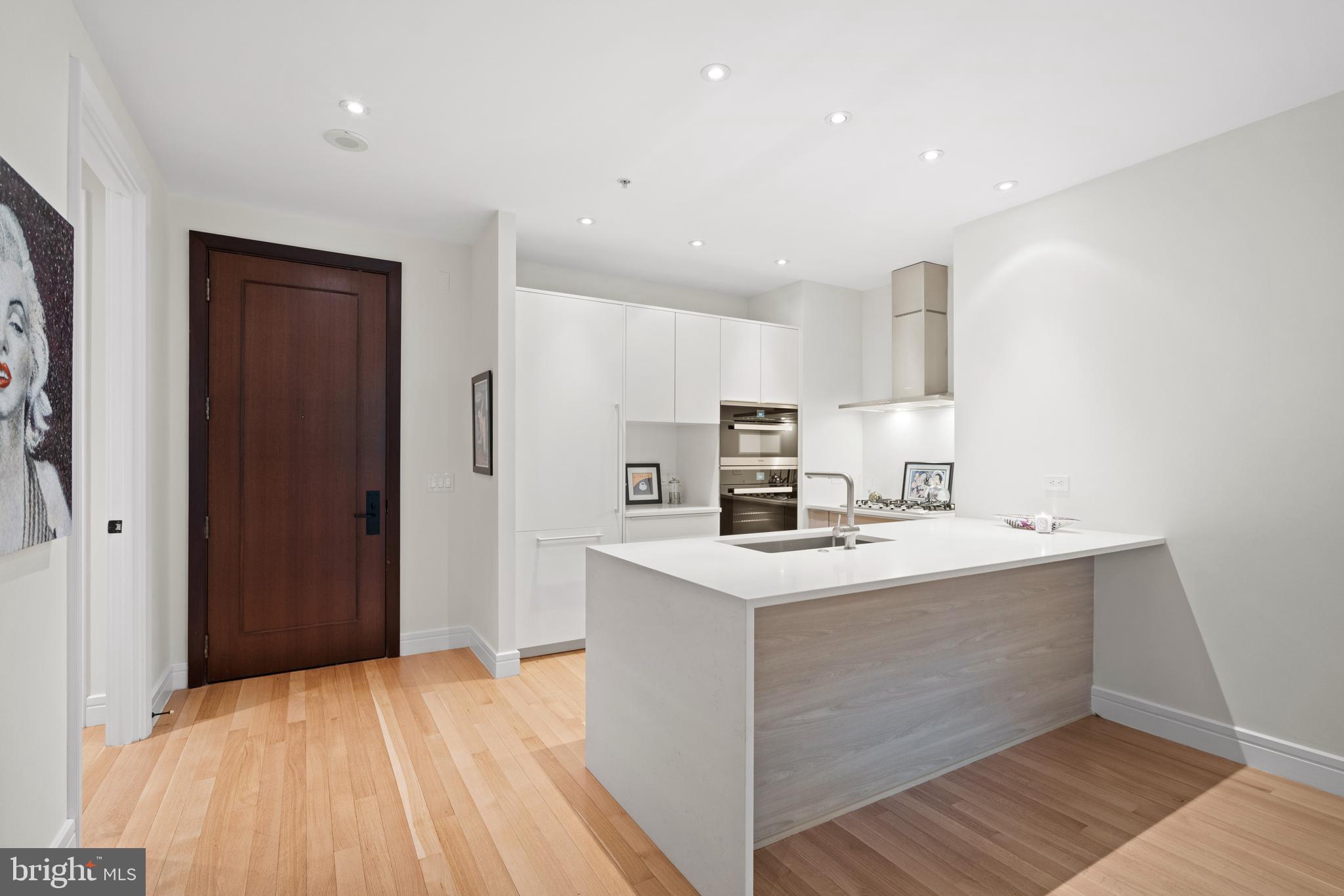 3303 Water Street Northwest, Unit 3B Washington, DC 20007 - Photo 3 of 25 a kitchen with a sink a stove a refrigerator and cabinets