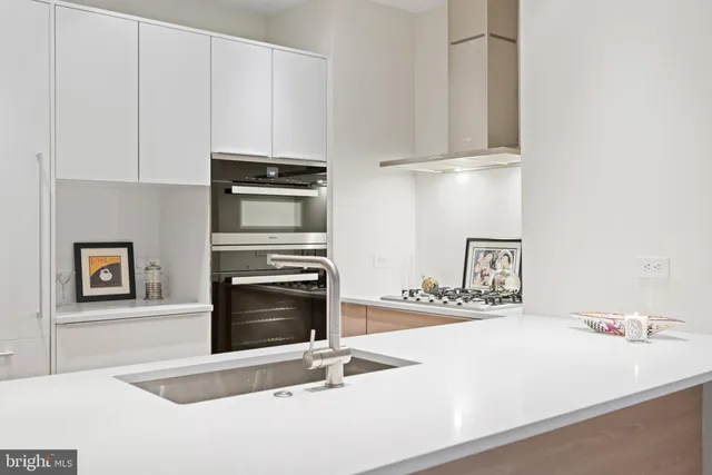 a kitchen with granite countertop a stove and a sink