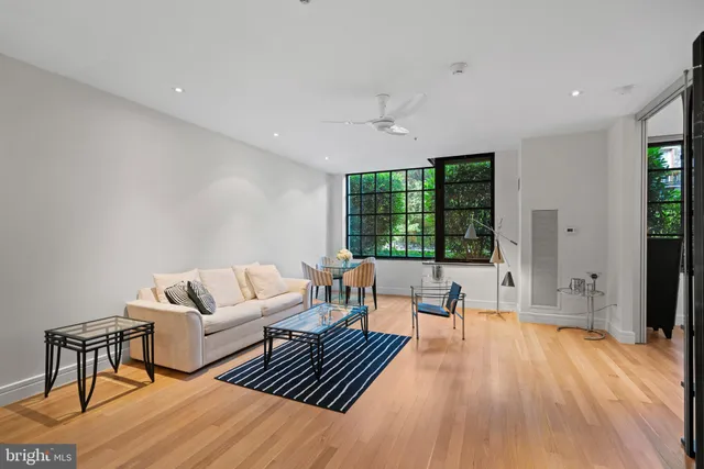 a living room with furniture and a large window