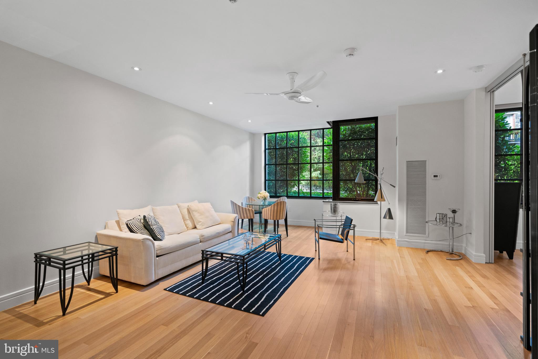 3303 Water Street Northwest, Unit 3B Washington, DC 20007 - Photo 5 of 25 a living room with furniture and a large window