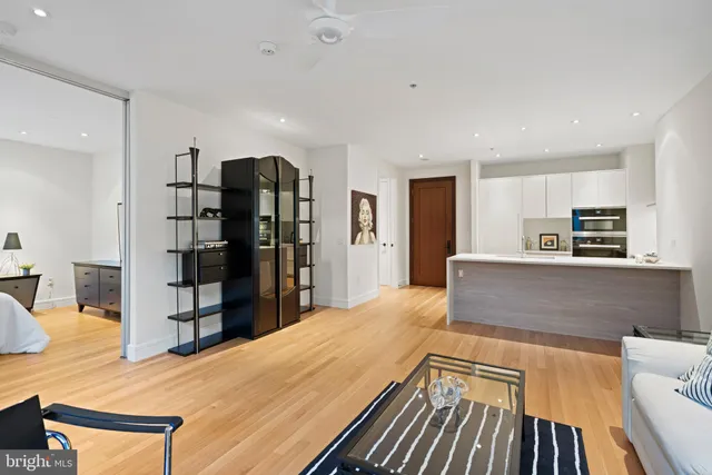 a living room with stainless steel appliances kitchen island furniture and a kitchen view