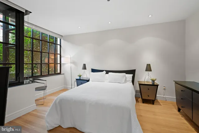 a bedroom with a large bed and a large window