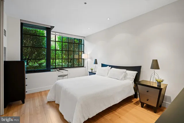 a bed sitting in a bedroom next to a window