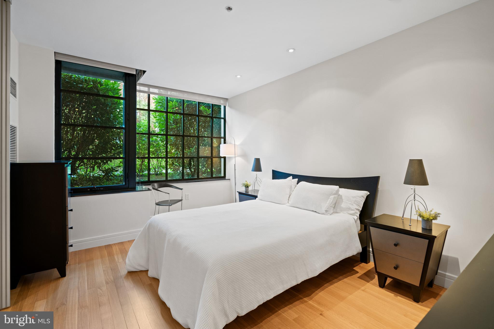 3303 Water Street Northwest, Unit 3B Washington, DC 20007 - Photo 10 of 25 a bed sitting in a bedroom next to a window