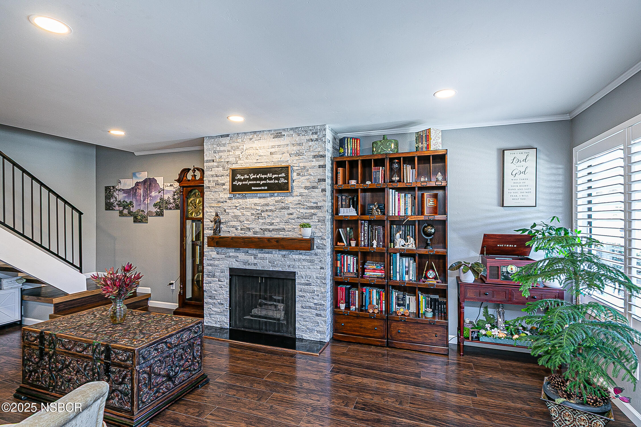 1193 Sumner Place, Unit C Santa Maria, CA 93455 - Photo 4 of 22 a living room with furniture a bookshelf and a fireplace