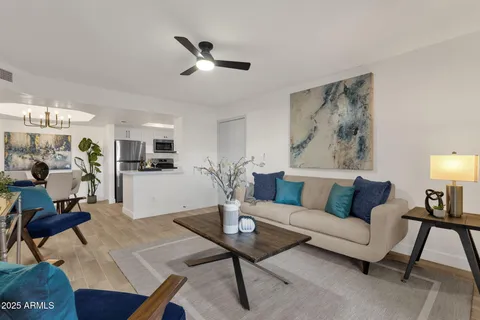 a living room with furniture and wooden floor
