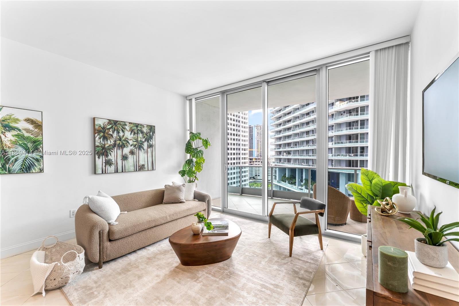 1331 Brickell Bay Drive, Unit 1706 Miami, FL 33131 - Photo 2 of 17 a living room with furniture and a potted plant
