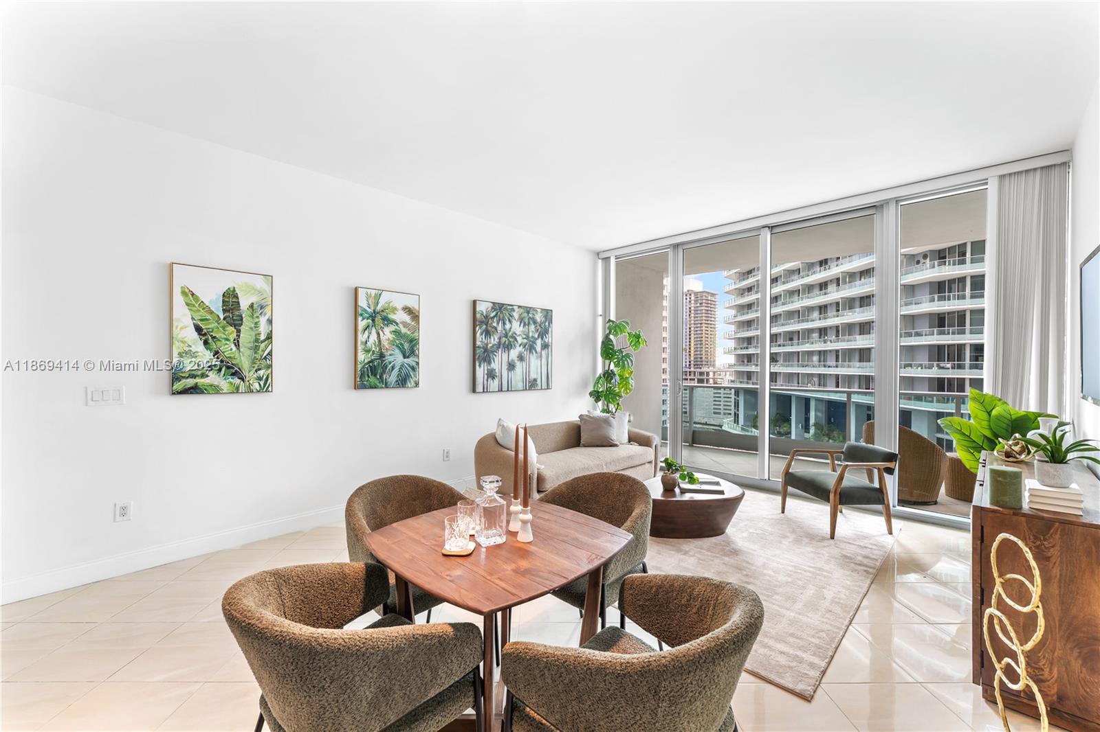 1331 Brickell Bay Drive, Unit 1706 Miami, FL 33131 - Photo 4 of 17 a living room with furniture and a potted plant