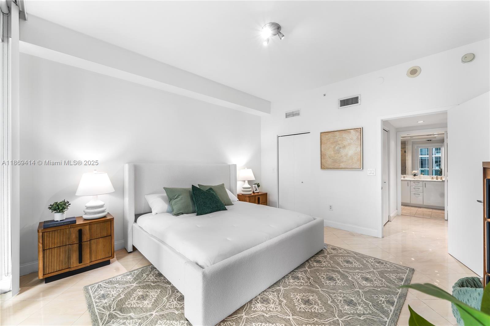 1331 Brickell Bay Drive, Unit 1706 Miami, FL 33131 - Photo 9 of 17 a bedroom with a large bed and a couch