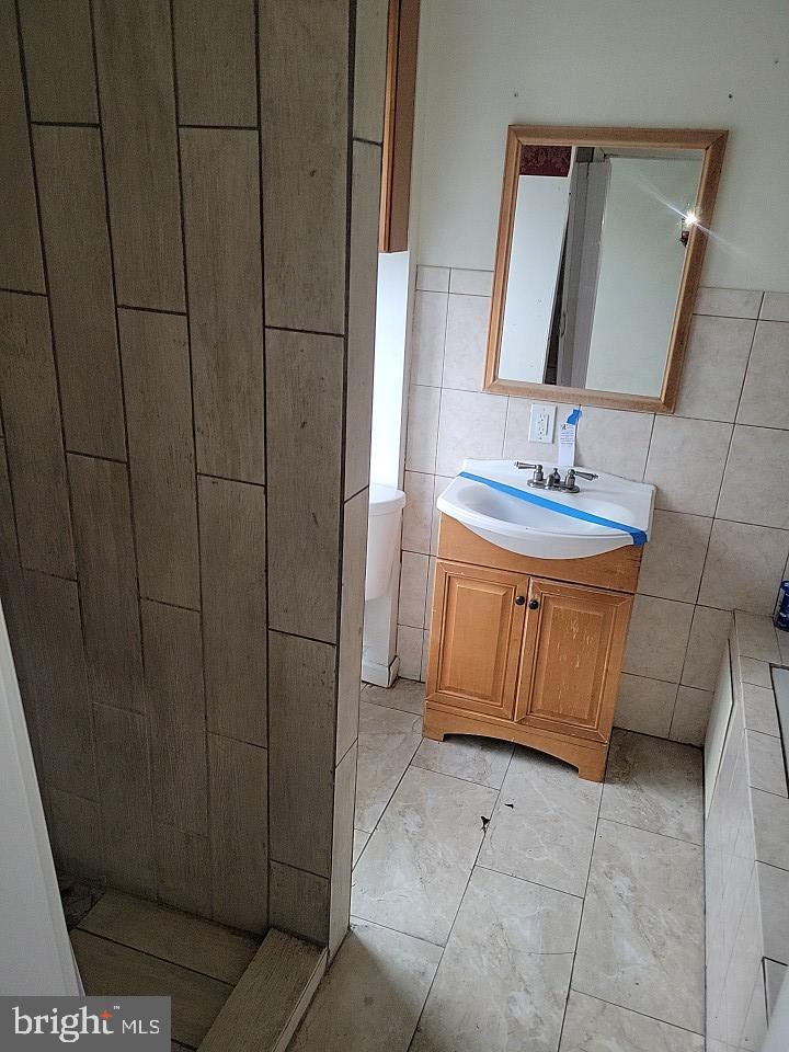 3011 Kenyon Avenue Baltimore, MD 21213 - Photo 12 of 14 a bathroom with a sink a toilet and mirror