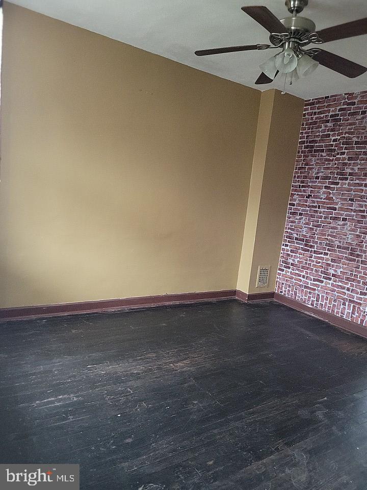 3011 Kenyon Avenue Baltimore, MD 21213 - Photo 4 of 14 a view of an empty room and wooden floor
