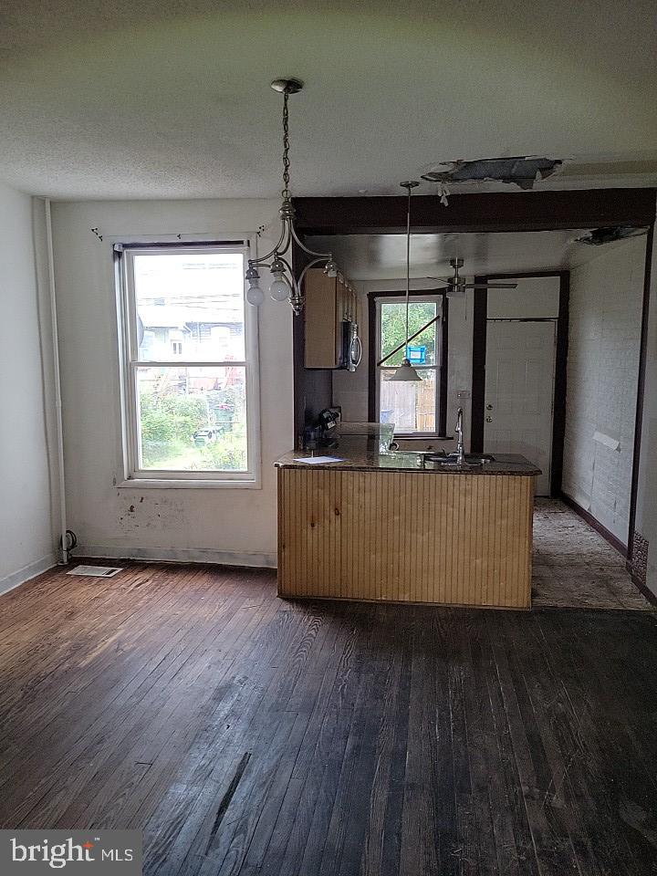 3011 Kenyon Avenue Baltimore, MD 21213 - Photo 5 of 14 an empty room with wooden floor and windows