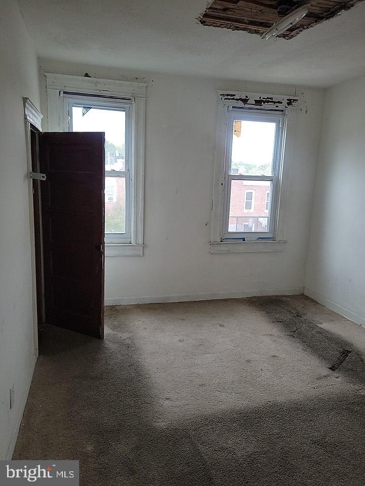 3011 Kenyon Avenue Baltimore, MD 21213 - Photo 8 of 14 an empty room with windows and closet