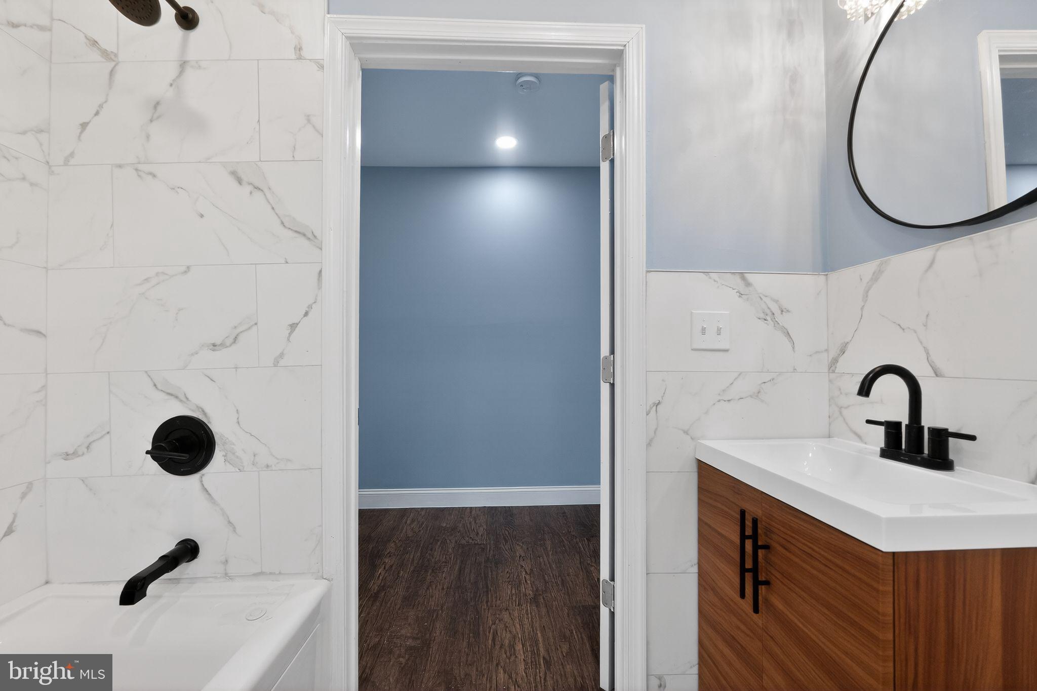 5018 Belair Road Baltimore, MD 21206 - Photo 23 of 32 a bathroom with a sink and a mirror