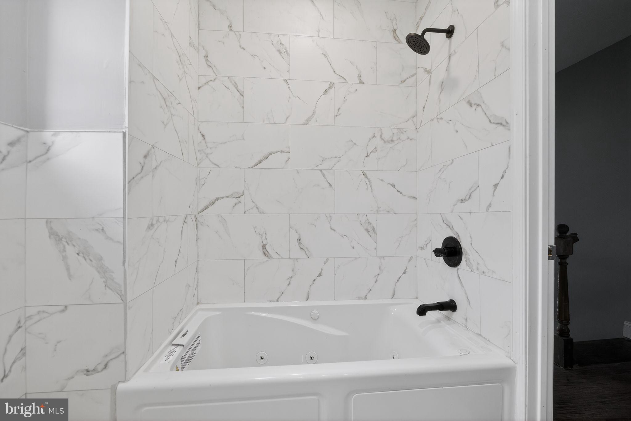 5018 Belair Road Baltimore, MD 21206 - Photo 25 of 32 a bathroom with a bathtub