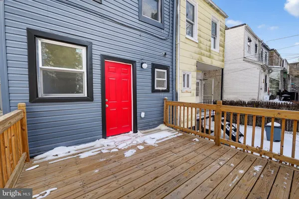 a view of a house with wooden deck