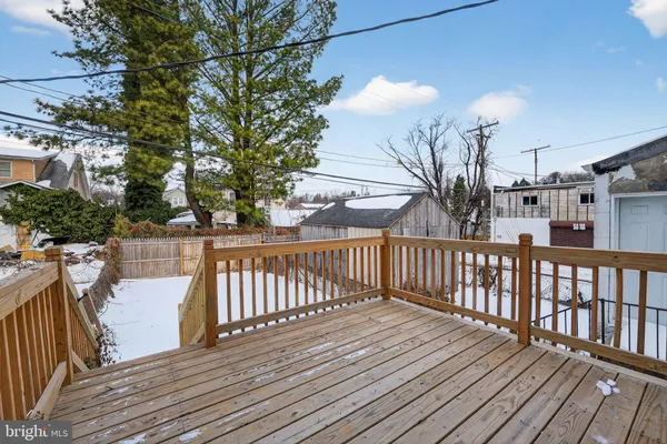 a view of balcony with wooden floor and fence