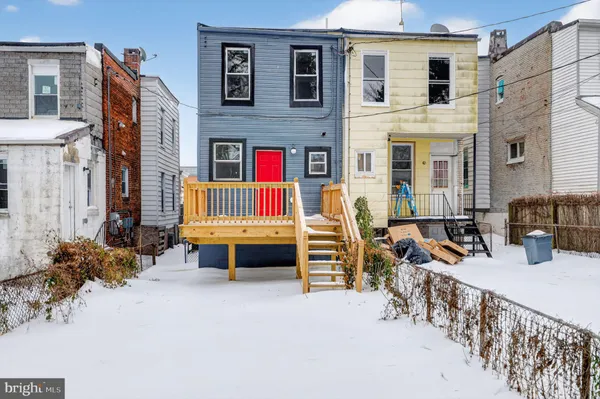 a backyard of a house with barbeque oven table and chairs