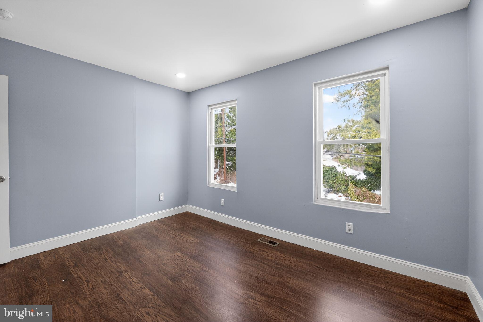 5018 Belair Road Baltimore, MD 21206 - Photo 5 of 32 a view of an empty room with wooden floor and a window