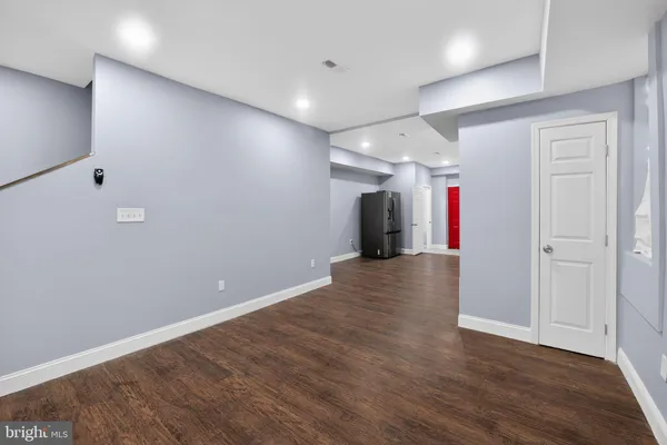 a view of an empty room with wooden floor