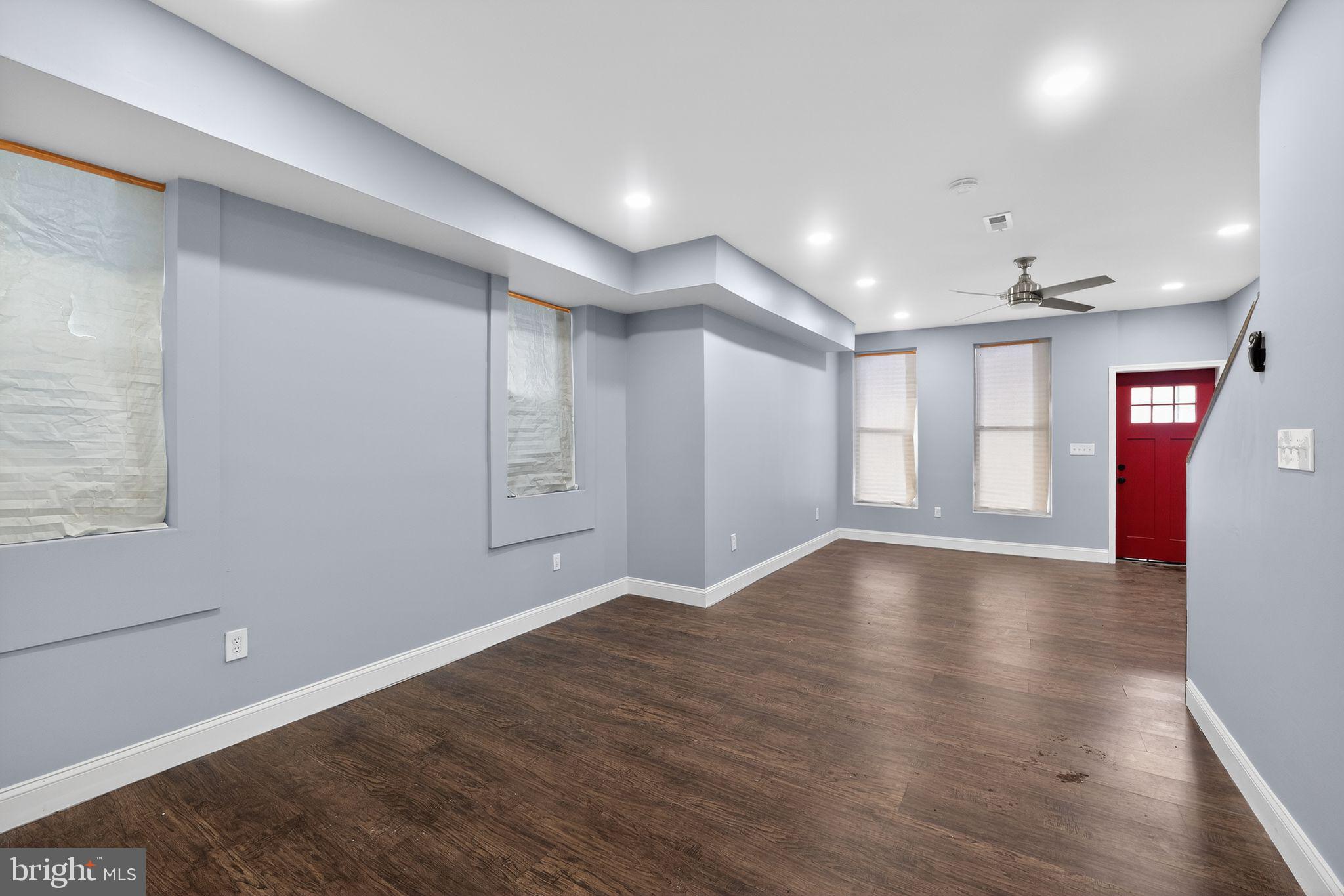 5018 Belair Road Baltimore, MD 21206 - Photo 7 of 32 a view of an empty room with window and wooden floor