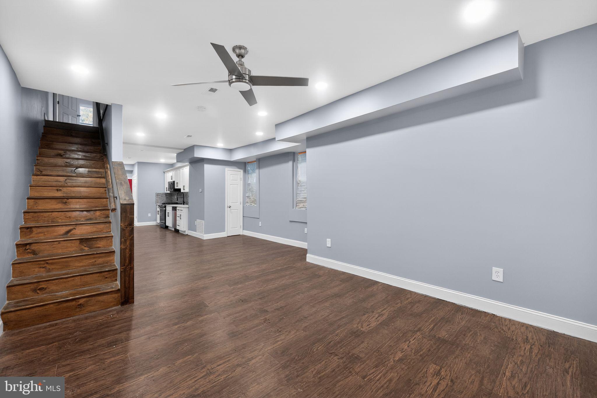 5018 Belair Road Baltimore, MD 21206 - Photo 9 of 32 an empty room with wooden floor and windows