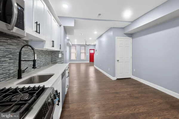 a kitchen with stainless steel appliances granite countertop a stove and a sink