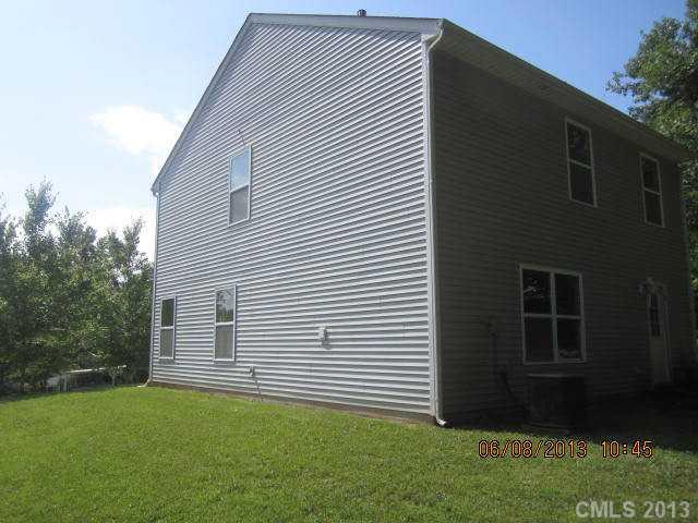 10 Riverside Street Lowell, NC 28098 - Photo 2 of 10 a backyard of a house with lots of green space