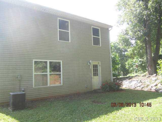 10 Riverside Street Lowell, NC 28098 - Photo 3 of 10 a front view of a house with a yard