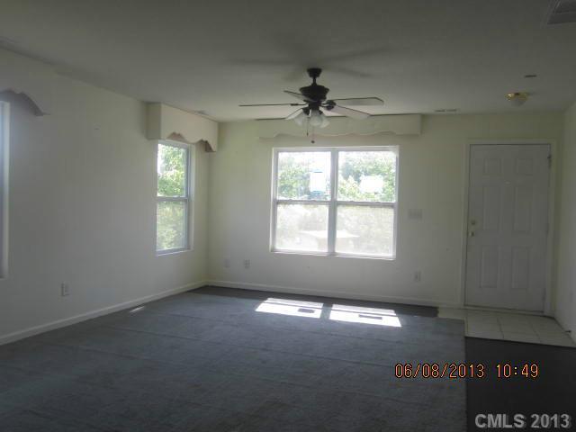 10 Riverside Street Lowell, NC 28098 - Photo 7 of 10 an empty room with a window and a ceiling fan