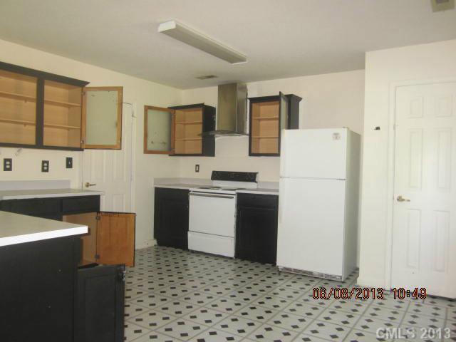 10 Riverside Street Lowell, NC 28098 - Photo 8 of 10 a kitchen with a refrigerator and a stove