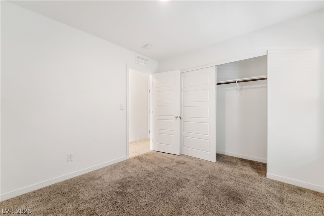 894 Cadence View Way Henderson, NV 89011 - Photo 9 of 23 A well-lit bedroom features ample floor space and a convenient closet for storage.