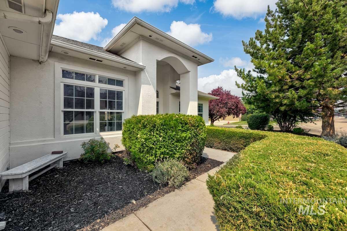 2575 S Bayou Meridian, ID 83642 - Photo 3 of 30 Stucco exterior with an arched entry, multiple pane windows, established landscaping, and a concrete pathway