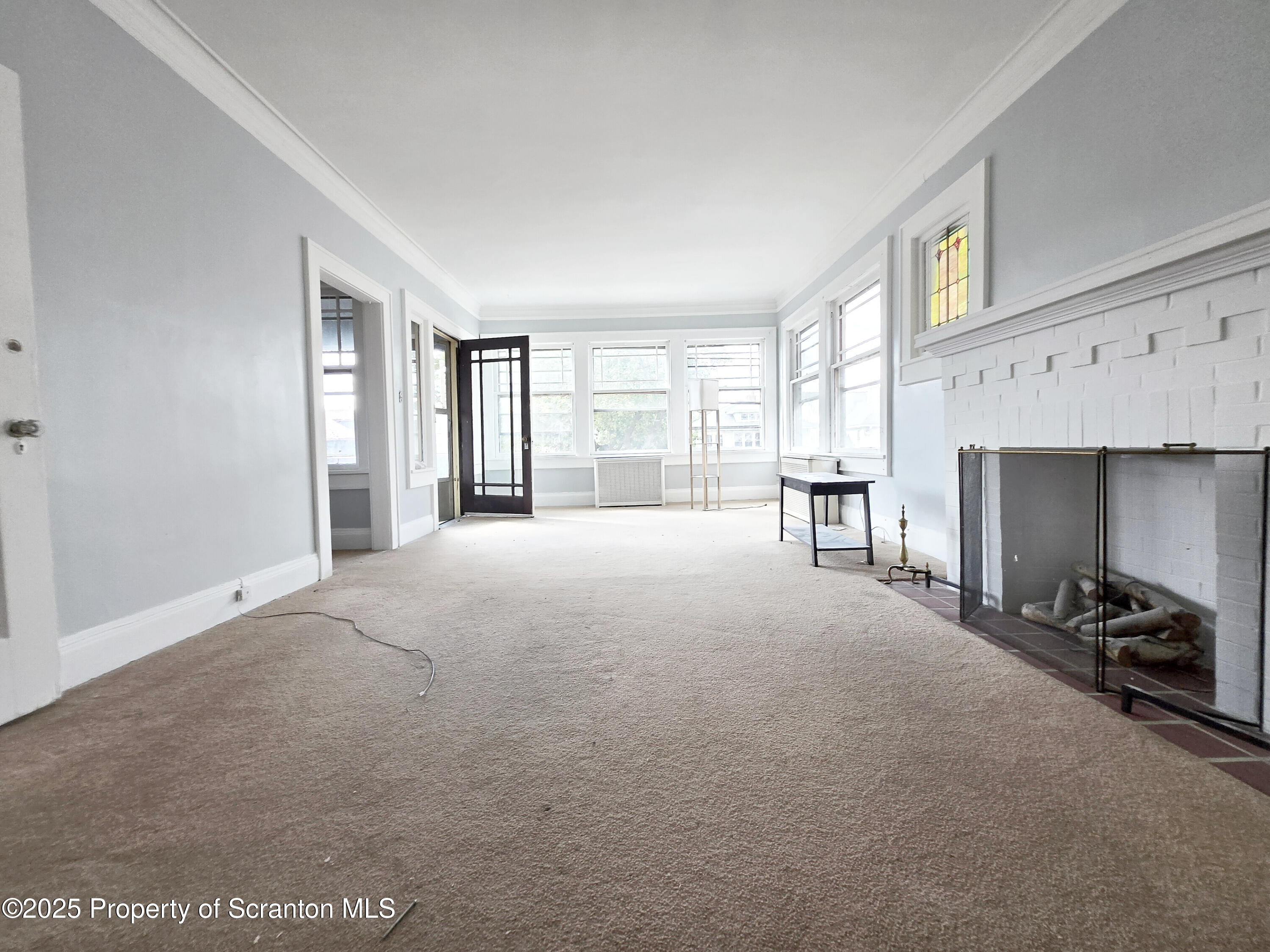 542 Colfax Avenue, Unit 2 Scranton, PA 18510 - Photo 2 of 15 a living room with furniture and a fireplace