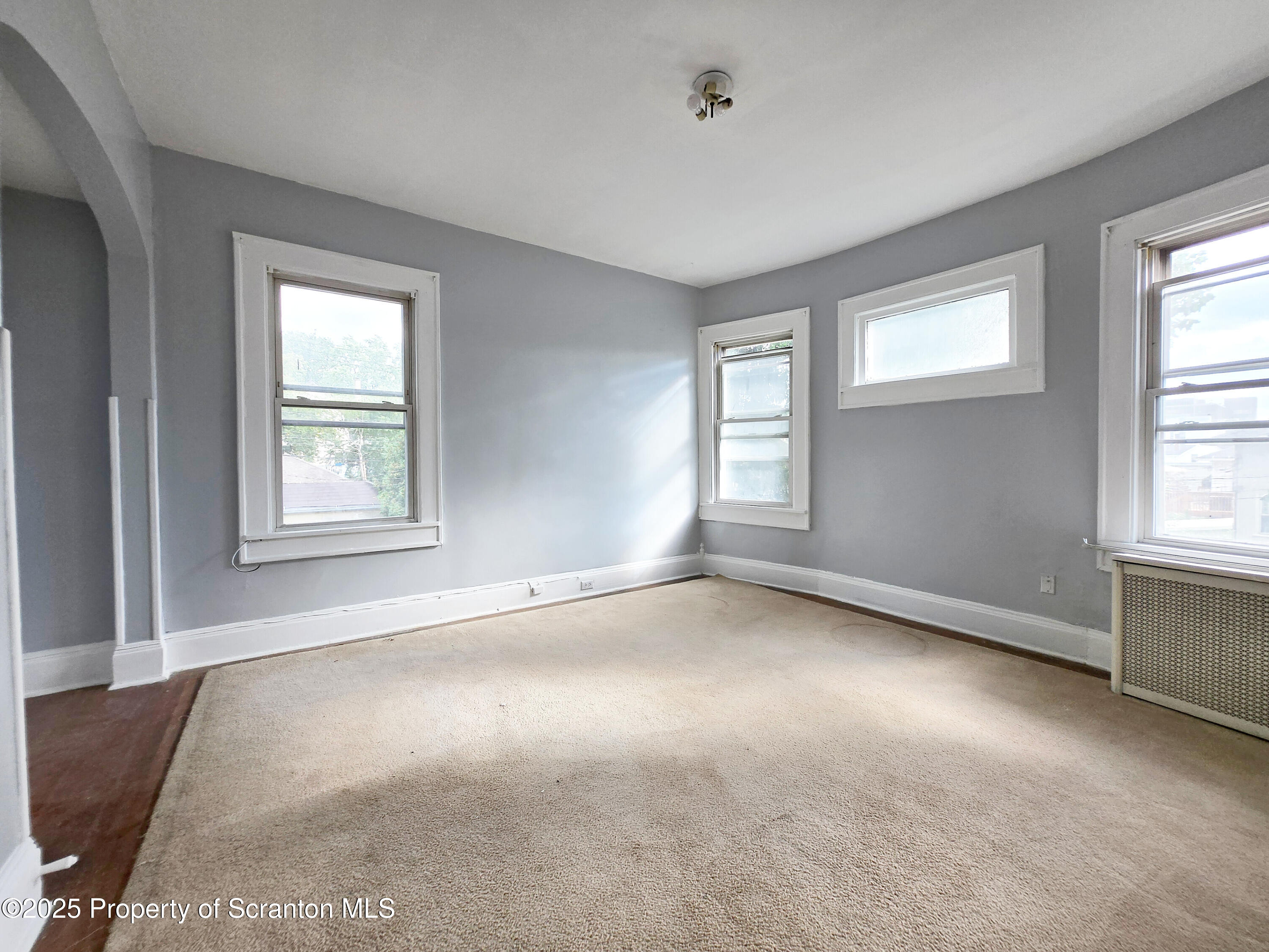 542 Colfax Avenue, Unit 2 Scranton, PA 18510 - Photo 10 of 15 an empty room with windows