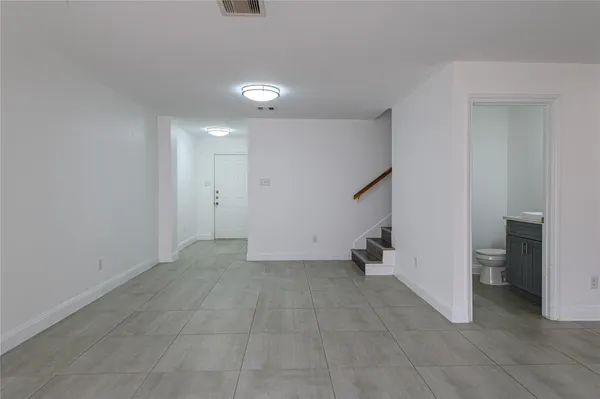 a view of an empty room with a closet