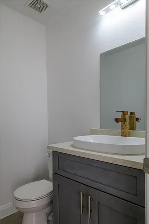 a bathroom with a sink a toilet and vanity