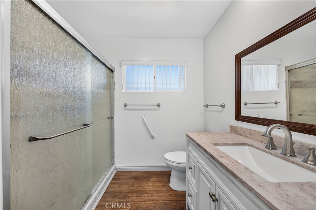 29078 Bradley Road Menifee, CA 92586 - Photo 22 of 42 a bathroom with a granite countertop sink toilet and shower