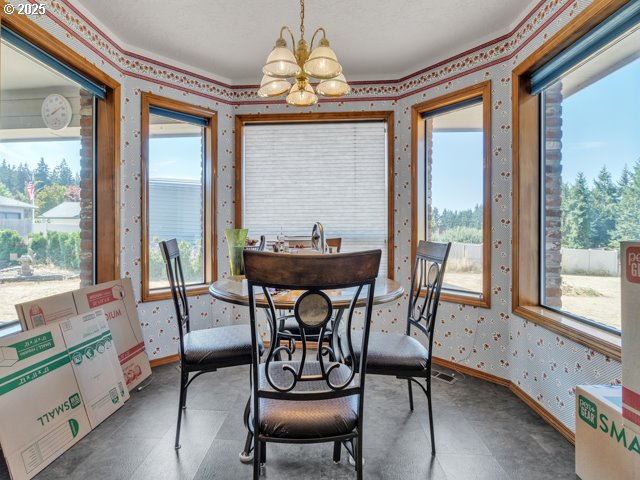6593 Rippling Brook Drive Southeast Salem, OR 97317 - Photo 11 of 48 a dining room with furniture a chandelier and wooden floor