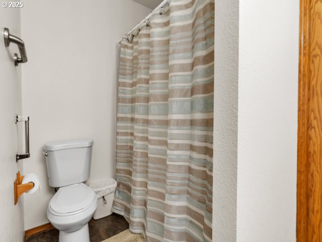 6593 Rippling Brook Drive Southeast Salem, OR 97317 - Photo 14 of 48 a white toilet sitting next to a shower curtain