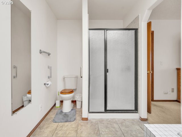 6593 Rippling Brook Drive Southeast Salem, OR 97317 - Photo 21 of 48 a bathroom with a granite countertop toilet and a shower