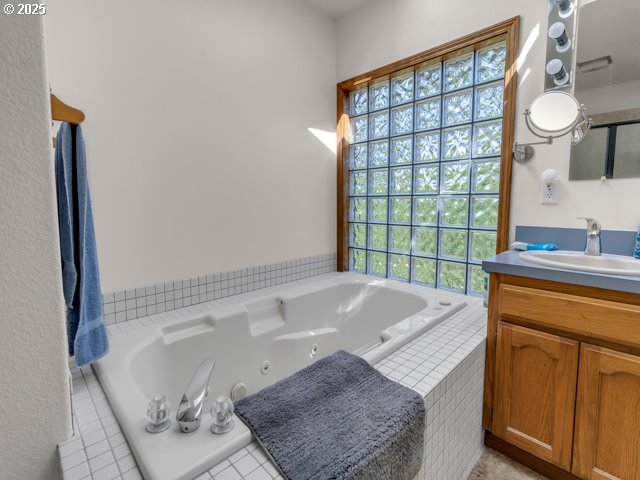 6593 Rippling Brook Drive Southeast Salem, OR 97317 - Photo 23 of 48 a spacious bathroom with a granite countertop sink and a mirror