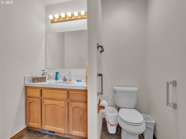 6593 Rippling Brook Drive Southeast Salem, OR 97317 - Photo 26 of 48 a bathroom with a toilet a sink and mirror