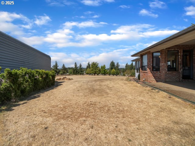 6593 Rippling Brook Drive Southeast Salem, OR 97317 - Photo 29 of 48 a view of an house with backyard and bushes