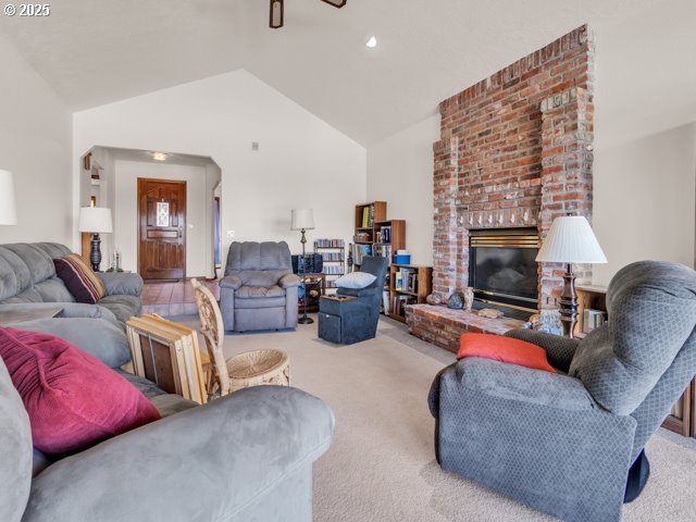 6593 Rippling Brook Drive Southeast Salem, OR 97317 - Photo 4 of 48 a living room with furniture a fireplace and a flat screen tv