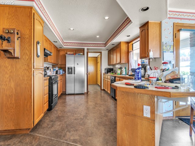 6593 Rippling Brook Drive Southeast Salem, OR 97317 - Photo 8 of 48 a kitchen with stainless steel appliances a refrigerator a sink a stove and island