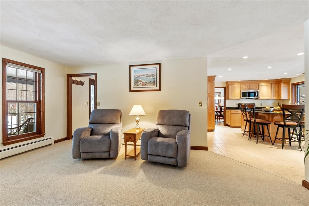 53 Throne Hill Road Groton, MA 01450 - Photo 16 of 38 a living room with furniture and a table with wooden floor